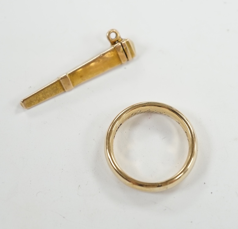 A 9ct gold wedding band, with engraved inscription, size Q and a yellow metal needle? case, 8.4 grams. Condition - fair